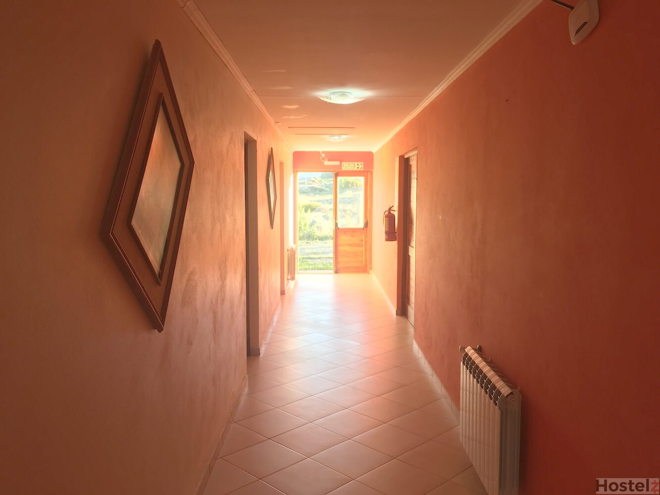 Central corridor with doors to rooms and kitchen