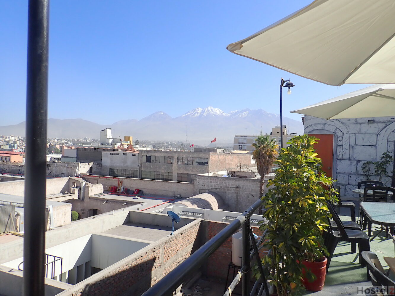 Rooftop views over the city and snow capped mountains/ volcano