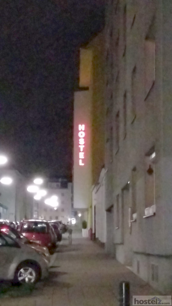Brightly lit hostel sign