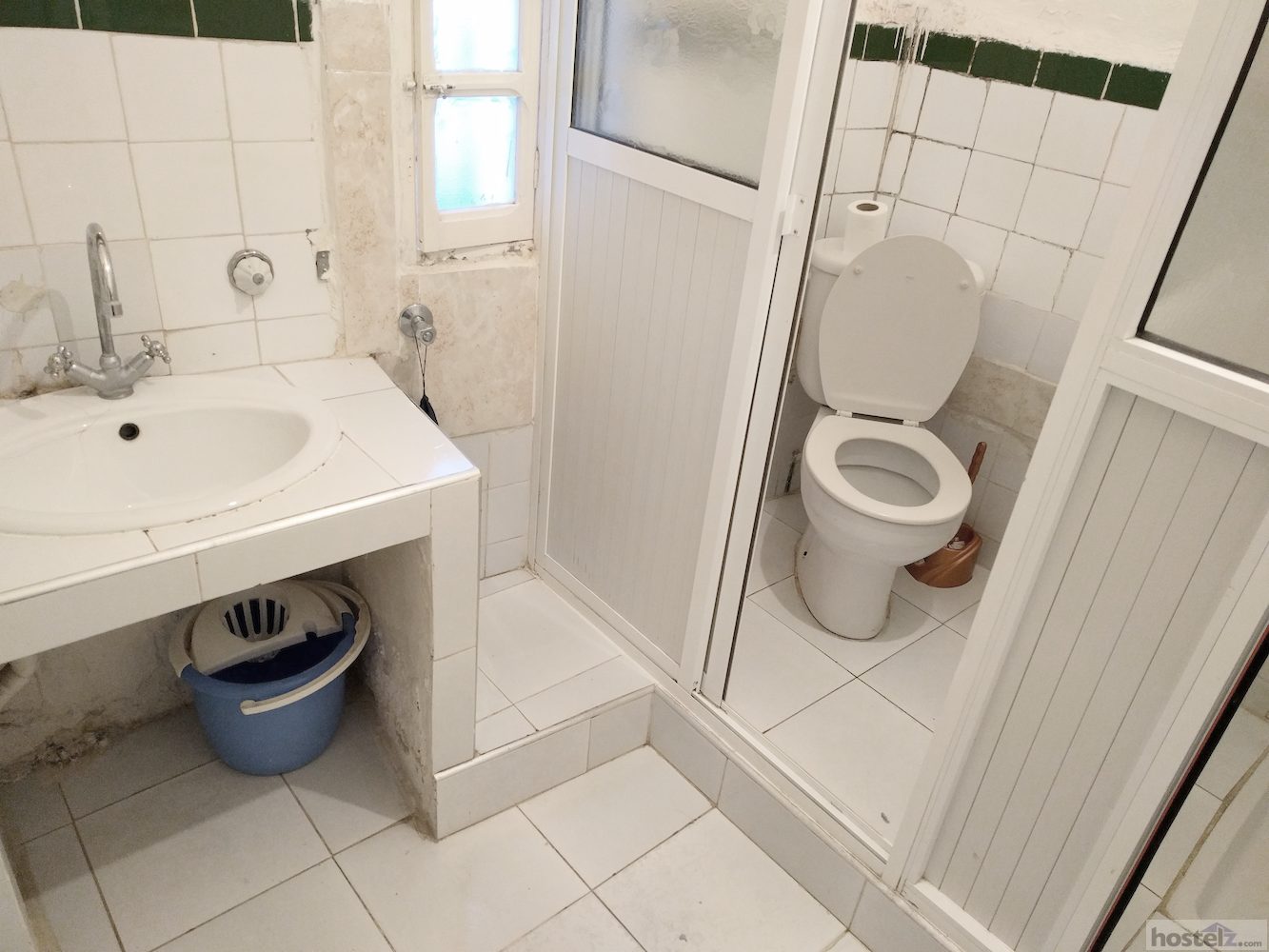 One of the bathrooms with a toilet and a shower, hooks, and plenty of room to change.