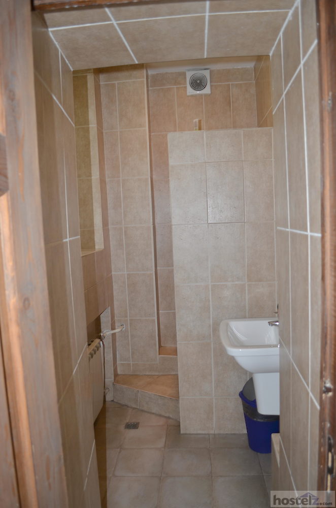 Bathroom with a corner shower and a sink