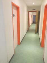 A hallway with doors to rooms on one of the floors
